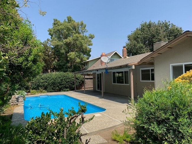 Building Photo - Enjoy the Backyard Pool at This 4-Bedroom ...