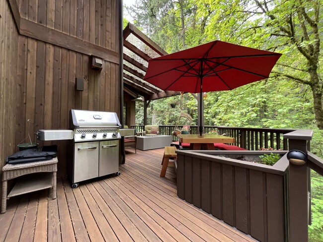 Building Photo - One-of-a-Kind Custom Home with Wall of Windows, Stone Fireplaces, Expansive Entertainment Space &...