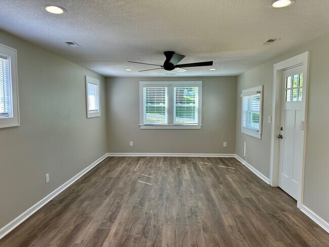 Family room with multiple windows, ceiling fan - 2304 Belle Ave NE