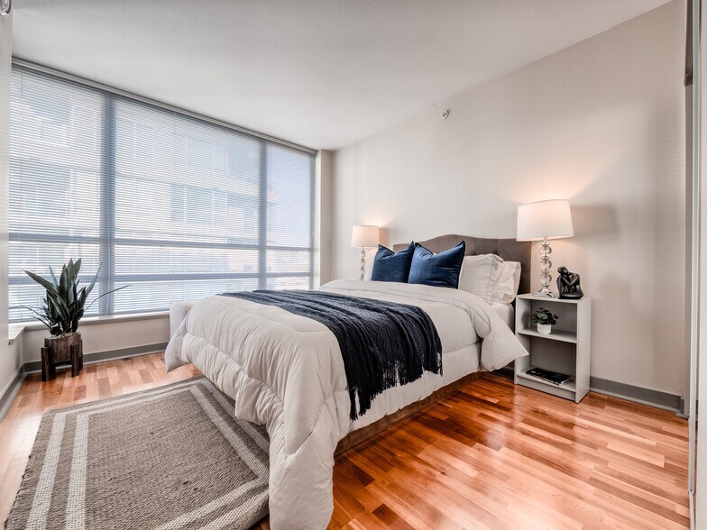 Turnkey bedroom sanctuary featuring pristine hardwoods and expansive mirrored storage - 2929 1st Ave