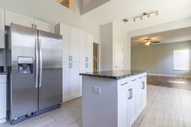 Building Photo - Beautiful 4/2 home Located on a tree lined street in the gate of country club community of the Hu...