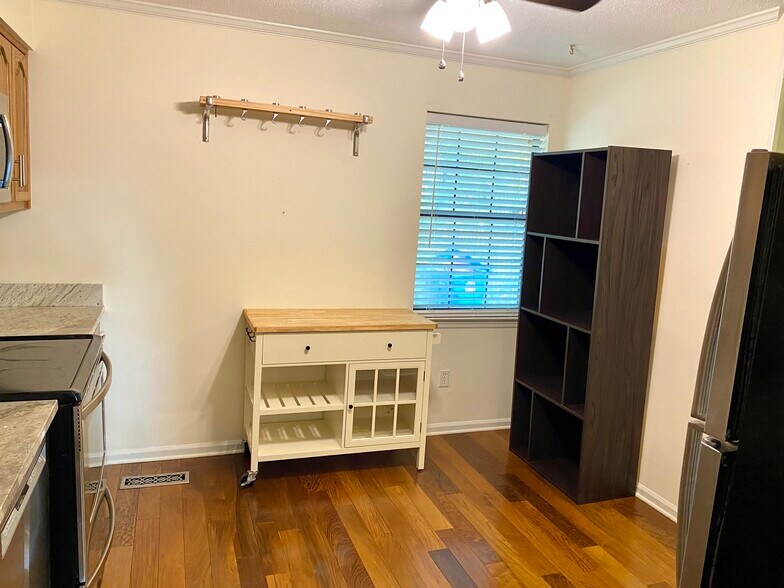 Lots of storage including island, pots and pans hanging shelf, and other shelves - 816 Oak St