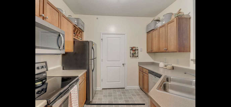 kitchen with stainless steel appliances, Bosch dishwasher, laundry in utility closet. - 735 Walker Square