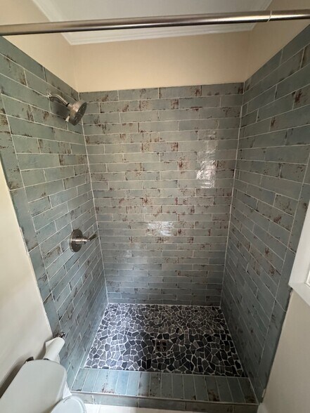 Bathroom 1 - all new tile surround, toilet, vanity, hardware and lighting - 406 Rosa Ave