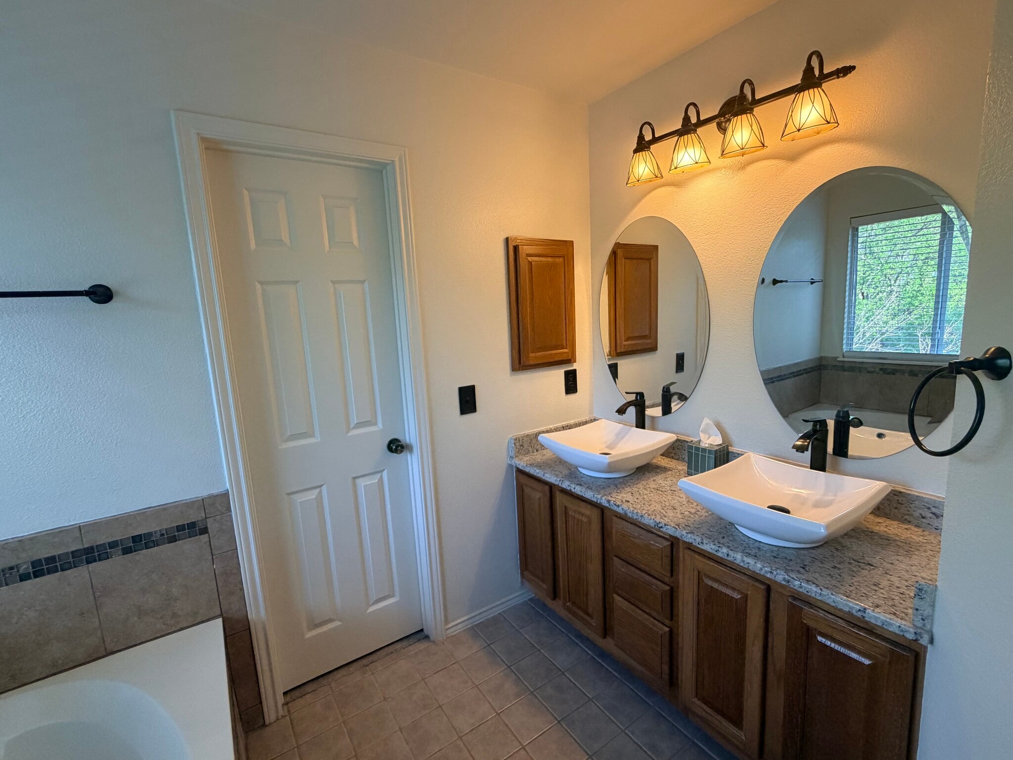 primary bath with double sinks and walk-in closet - 8516 Hillrock Dr