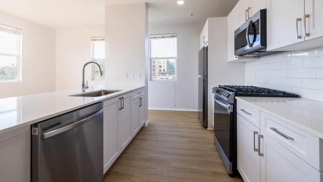 Kitchen with Stainless Steel Appliances - Bella Vista At Warner Ridge
