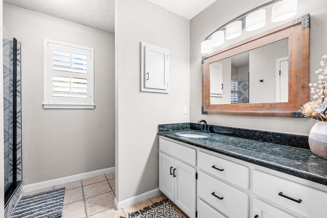 Primary bathroom with plenty of storage space and a brand new walk in shower! - 209 Prairie Wind Blvd