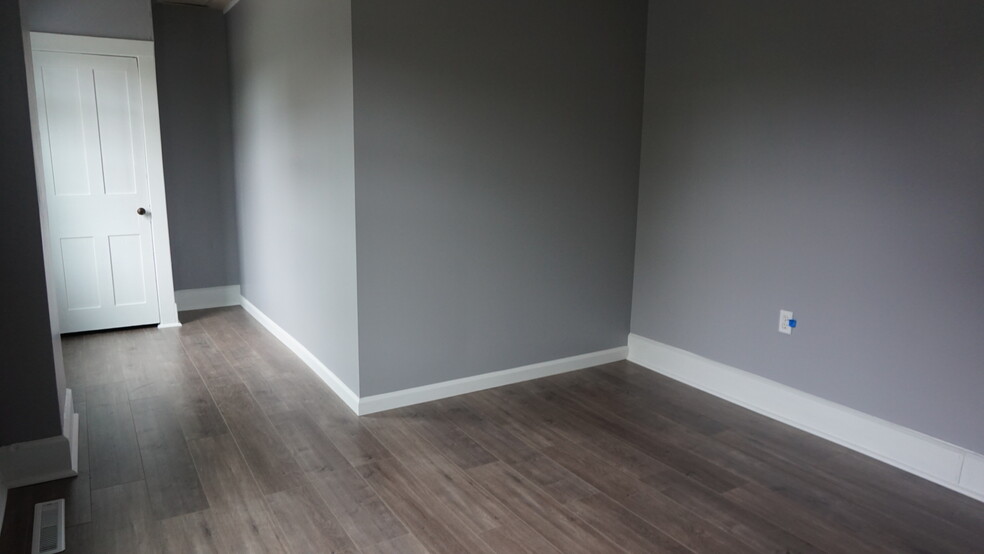 new flooring and fresh paint in the bedroom, throughout the whole unit actually! - 129 N Main St