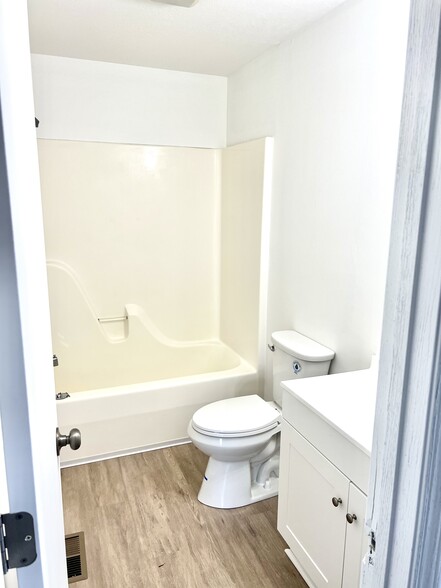 First bathroom with brand new toilet and vanity - 1921 Acorn Road