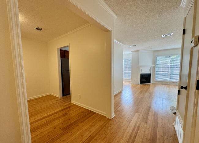 office/bonus room at left with doorway into kitchen, hall leading to living room at right - 209 14th St. NE #119