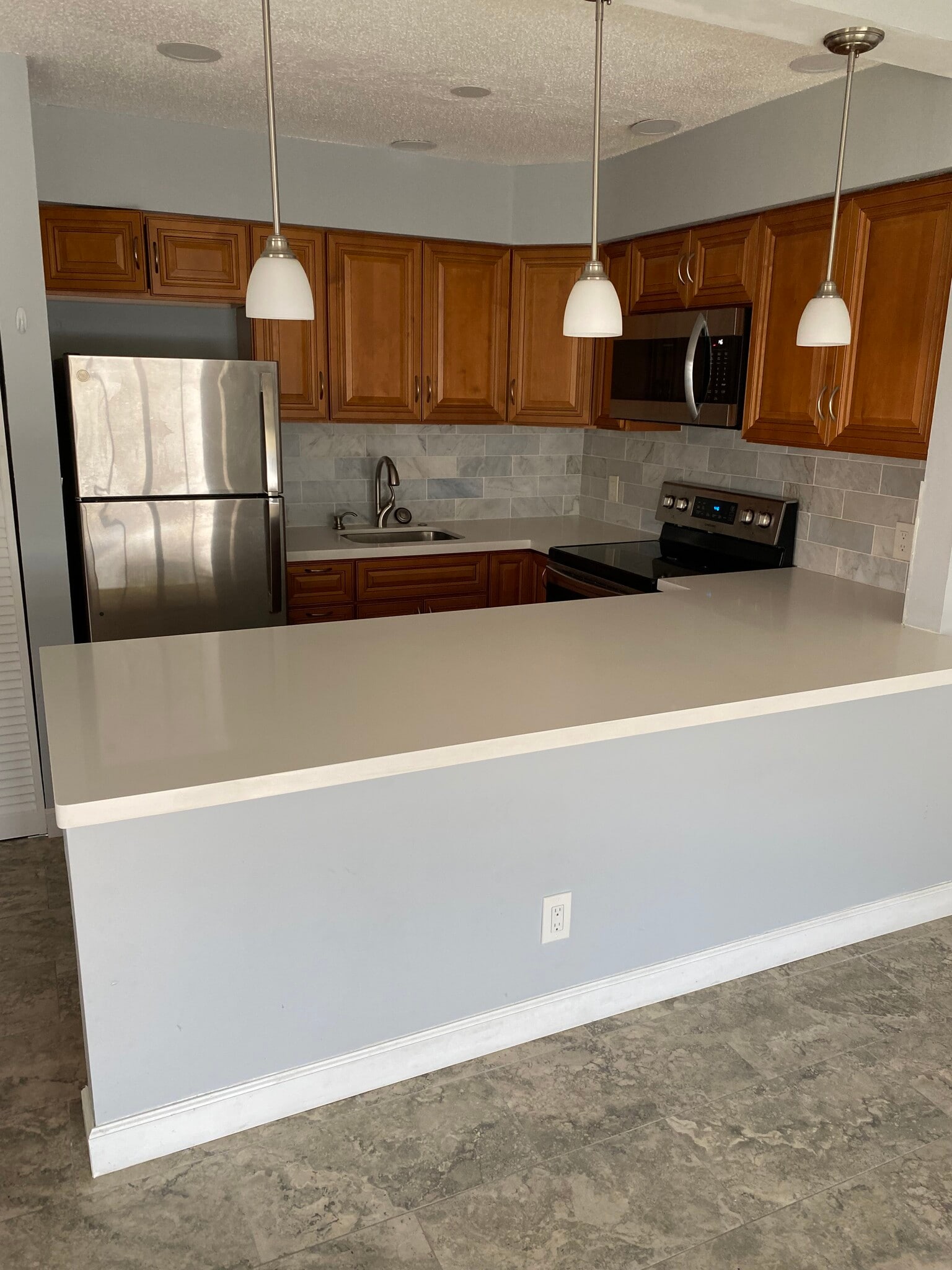 Pendant lighting over breakfast bar - 3049 NE 20th Ter