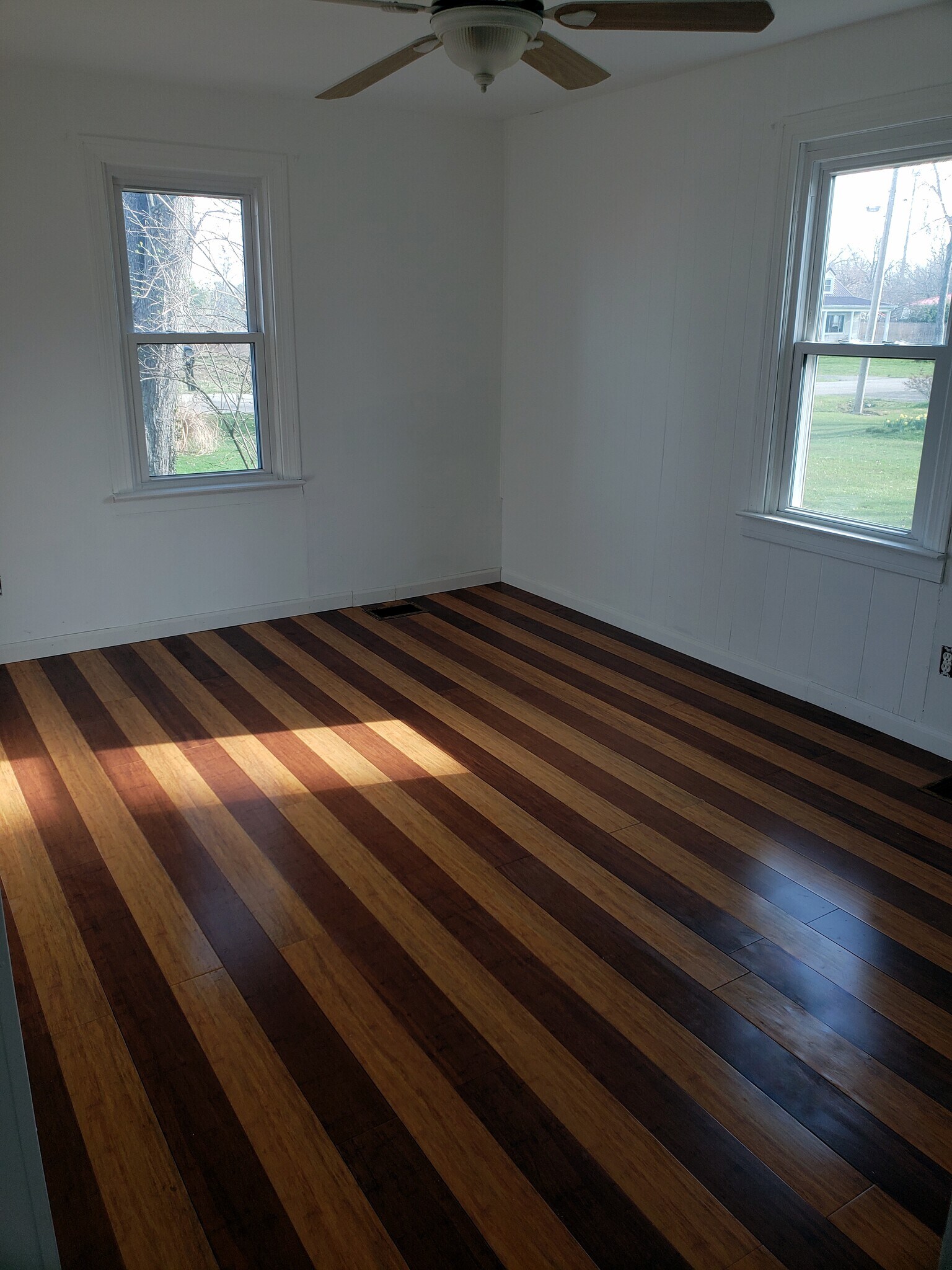 Bedroom at the front of the house has new bamboo flooring and ceiling fan. - 10106 Wingfield Rd