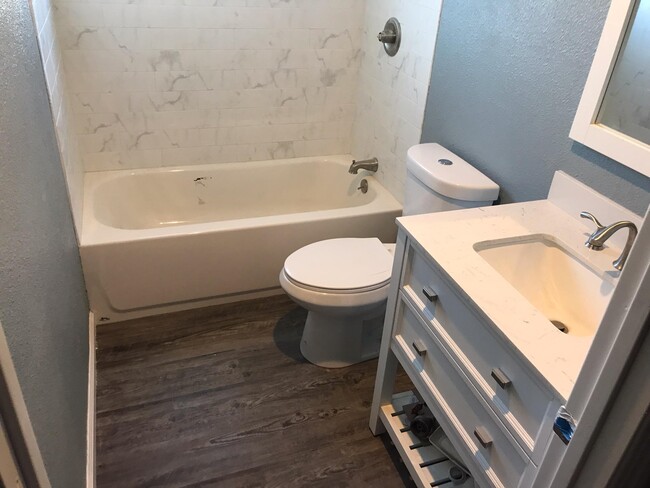 Bathroom walls freshly painted with new flooring and fixutures. Nickel finished glass shoor doors recently installed. Everything is new. - 1450 166th Ave