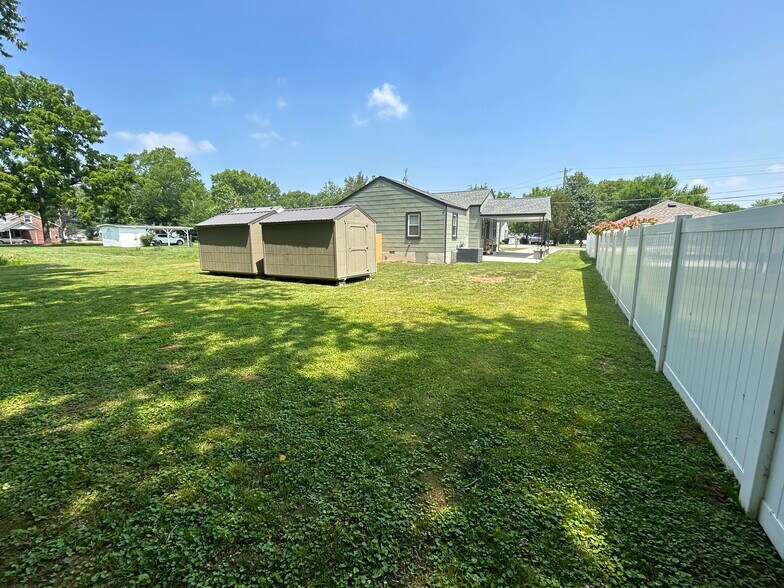 Rear yard showing new storage unit - 102 Ross Dr