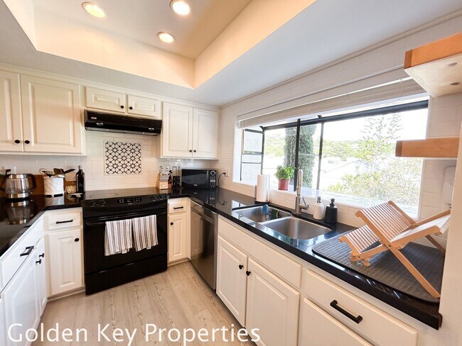 Building Photo - Welcome to this stunning ***unfurnished*** tri-level condo in the desirable Casitas de la Costa c...