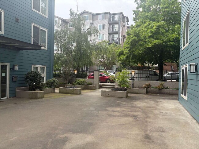 Building Photo - Bright, Modern 1BR Near Hospitals, SU & Transit in secure building with garage parking and a Walk...