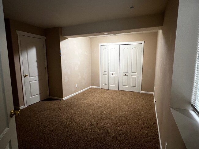 Lower Bedroom #2 with full Closet and Storage under Stairwell through Left Door - 5021 Mountain Man Ln