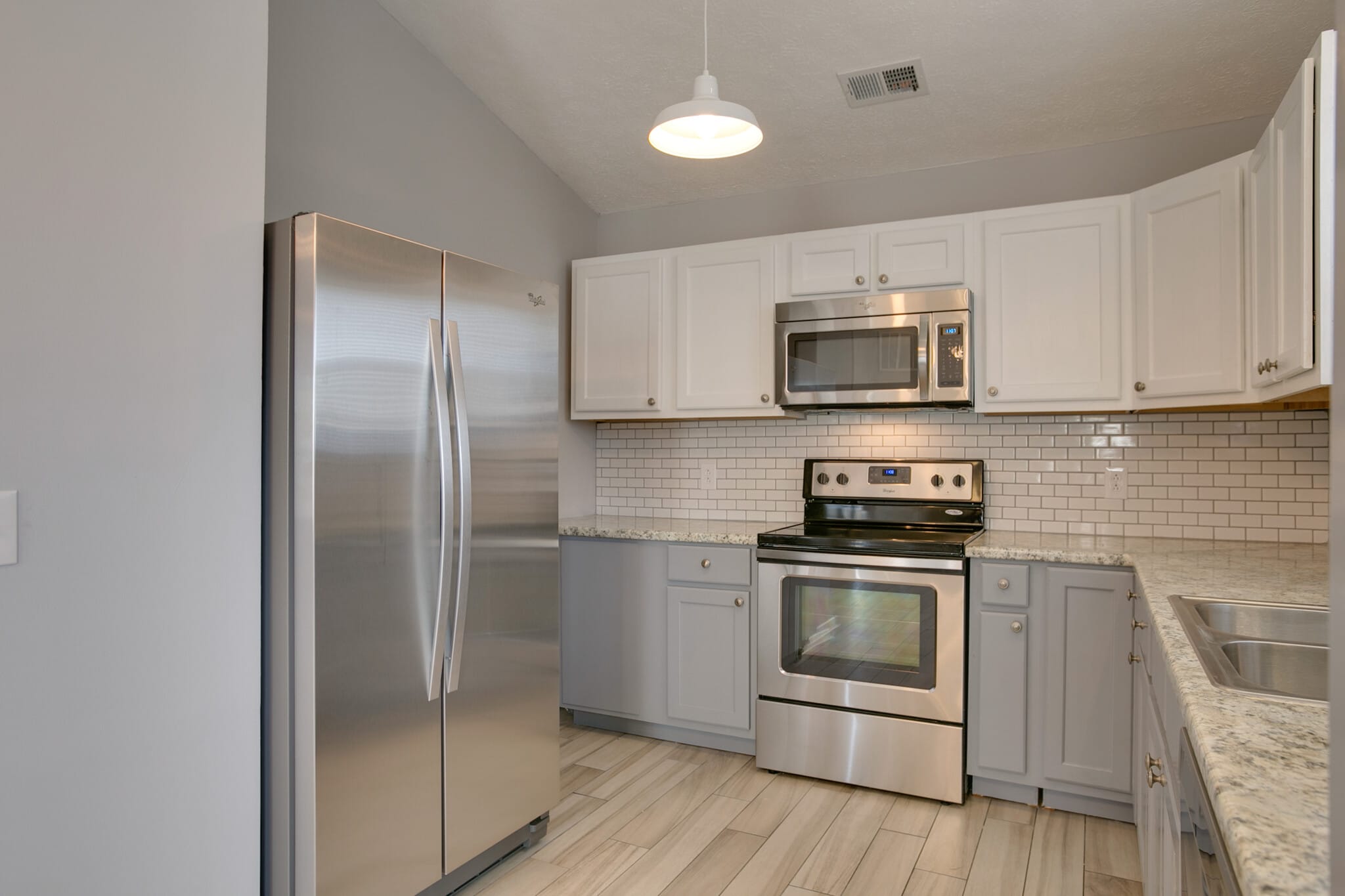 Washer dryer hookups tucked next to refrigerator - 1139 Alandee St.