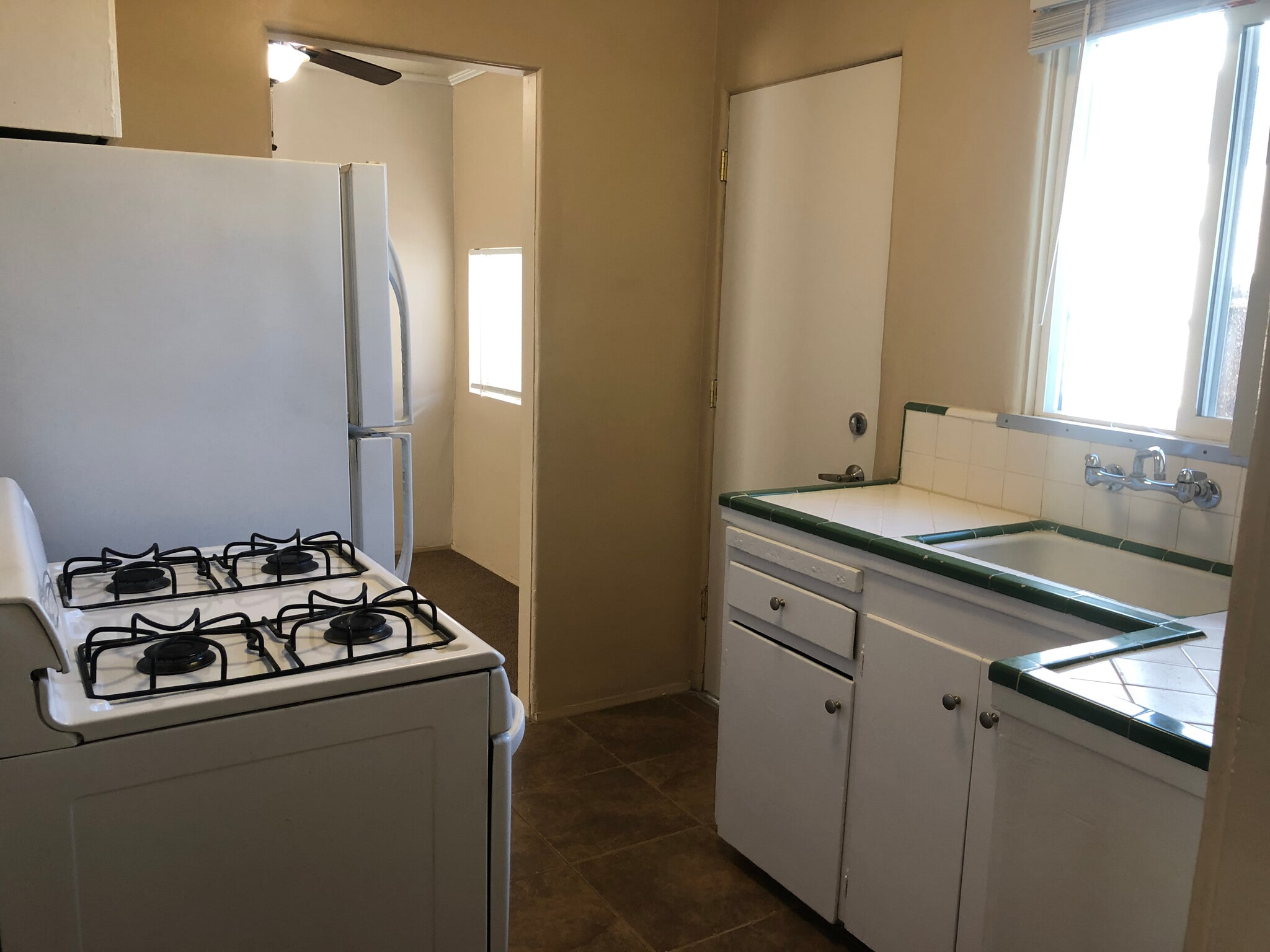 Kitchen: full-sized appliances, new light fixture, freshly painted cabinets, and new back door - 6432 Smoketree Ave