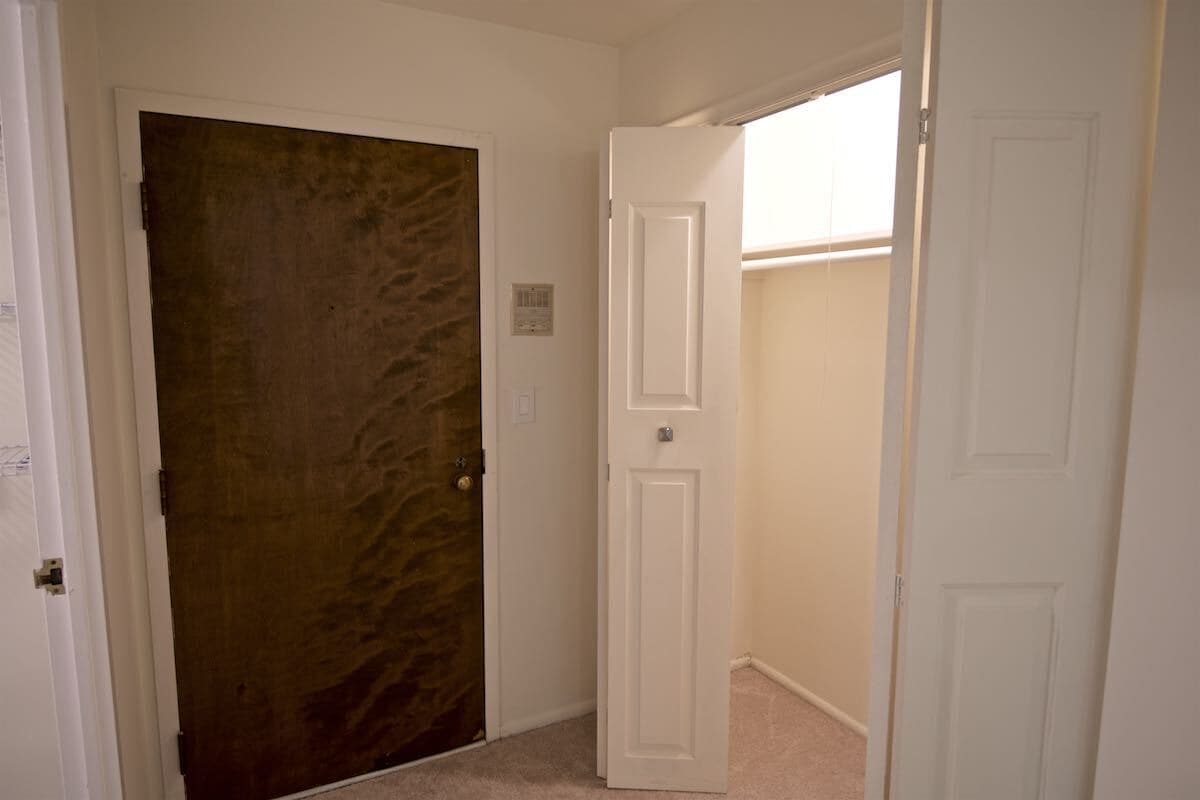Entry door to the unit, with coat closet - 1250 Park Ave W