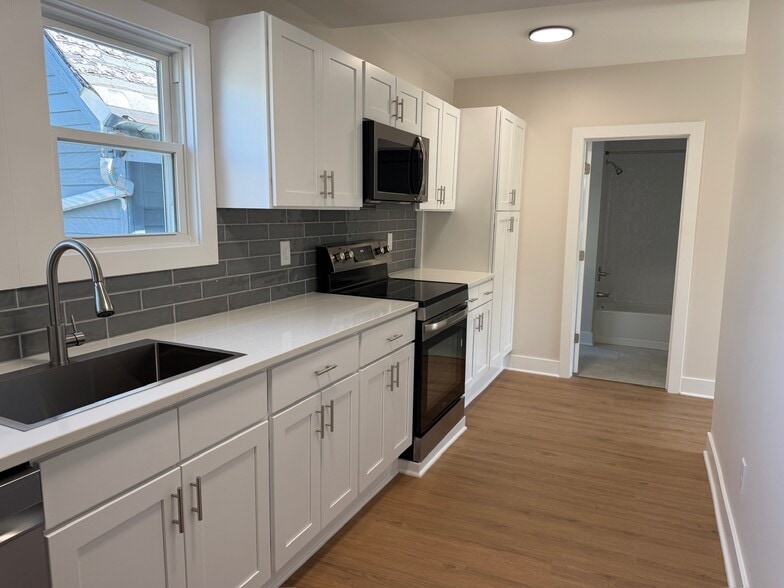 full kitchen with soft close cabinetry and quartz counters - 202 Vermont St