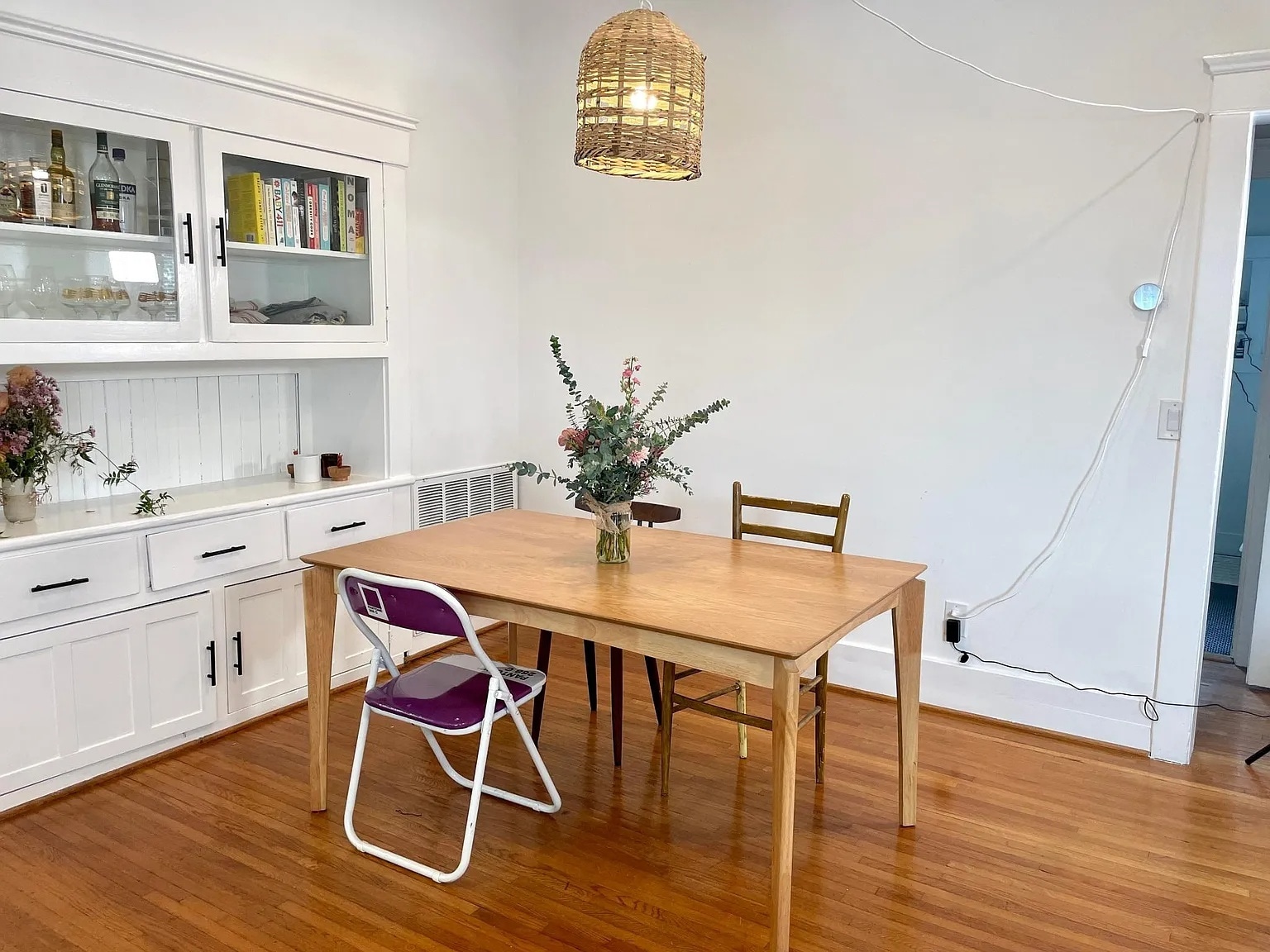 Inviting dining area with built-in cabinetry and hardwood floors. - 6000 Carlton Way
