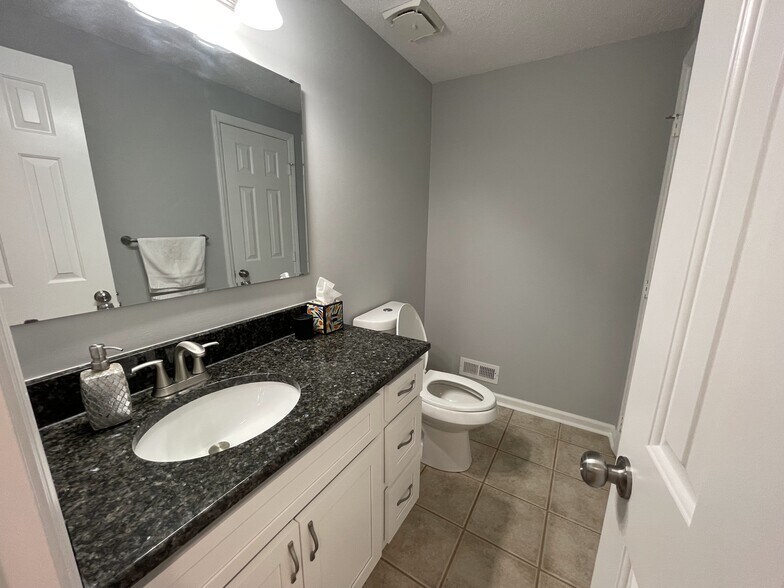 Downstairs half bath with granite countertops, real wood cabinets with soft close hinges/drawers, an - 4204 Whistler Ct
