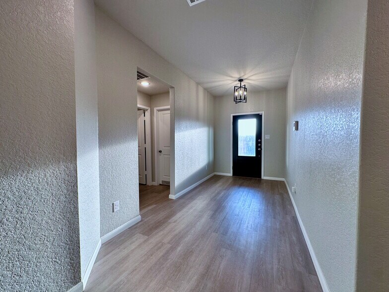 Front Entry - 2 Beds and 1 Bath left of picture, 1 Bed and 1 Bath next to garage entry on right - 32132 Morels Ave