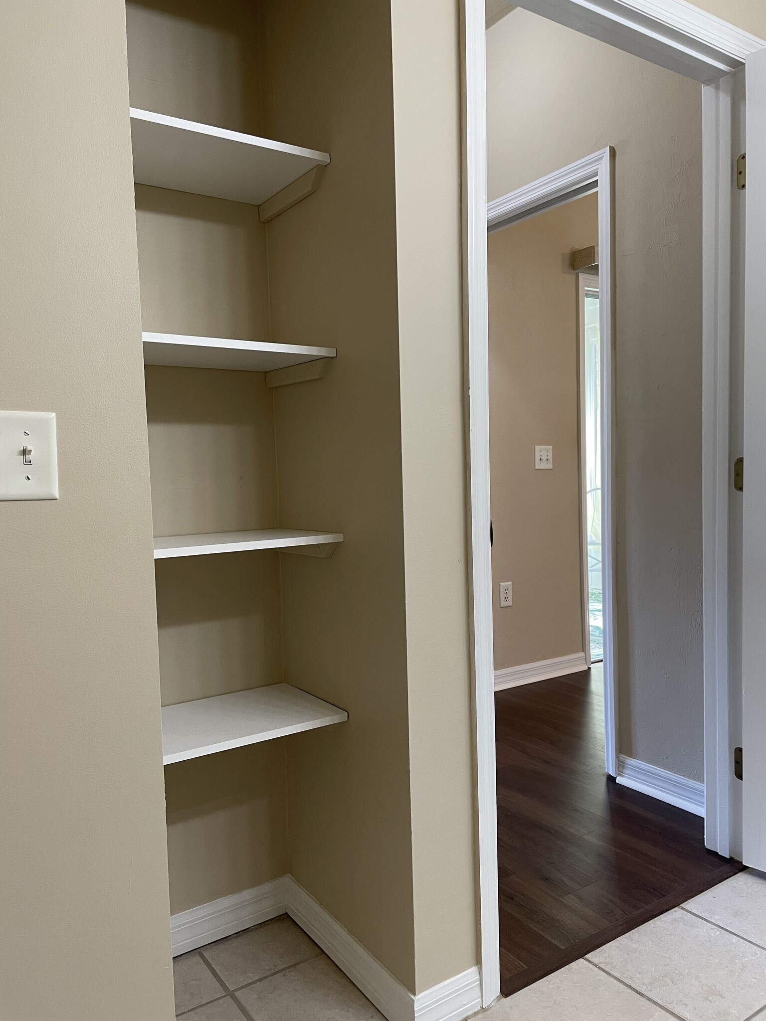 Tile in the bathroom allows for easy weekly cleaning including into the towel and shelving space. - 13200 W Newberry Rd