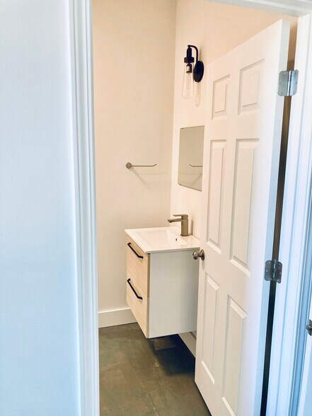 Modern Floating Vanity in Primary Bedroom En Suite Bath - 1311 Blair St