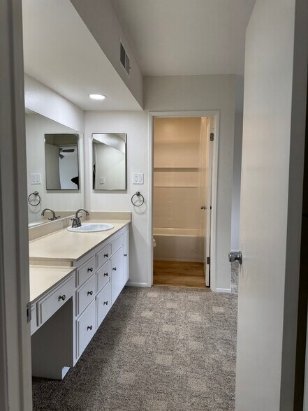 Hallway view to sink and bathroom - 400 N Acacia Ave