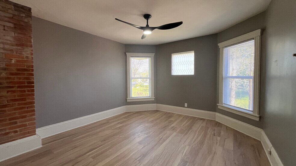 Bedroom with bay windows and exposed brick - 2366 E 85th St