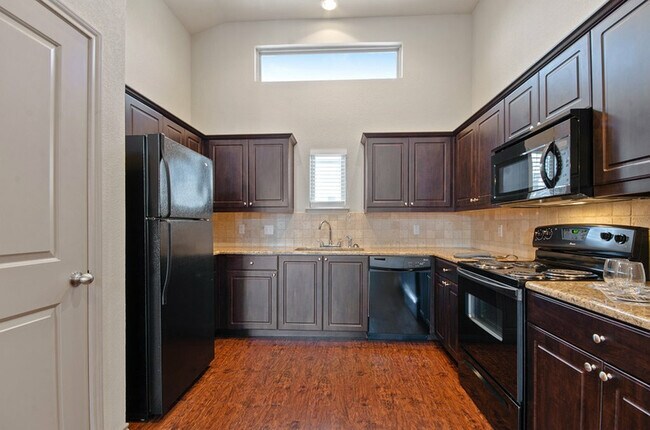 State of the art kitchen with black appliances - Tinsley Place