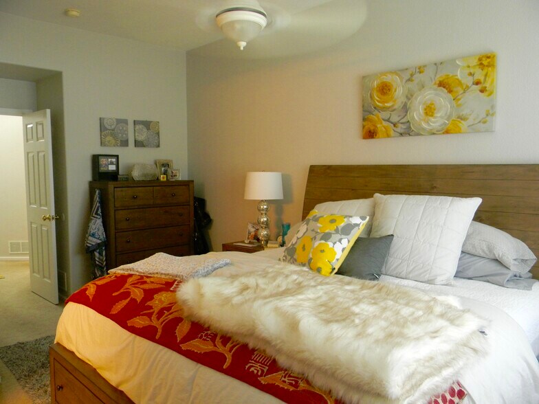 Spacious primary bedroom with new carpet and ceiling fan, adjoins 5-piece bath & massive closet! - 5835 S Harlan St
