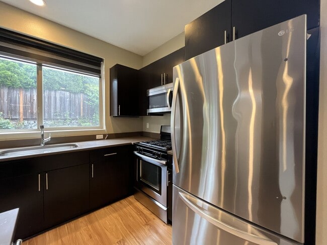 Building Photo - Charming 3 Bedroom, 2.5 Bathroom Home with Large Living Room, Tall Windows, Island Kitchen, and A...