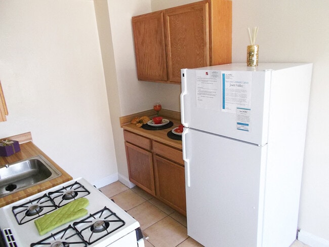 Galley Kitchen With White Appliances - ZZZOaklawn