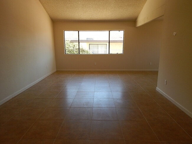 Building Photo - This property is a 3 bedroom, 2 bathroom home featuring an open floor plan with tile throughout. ...