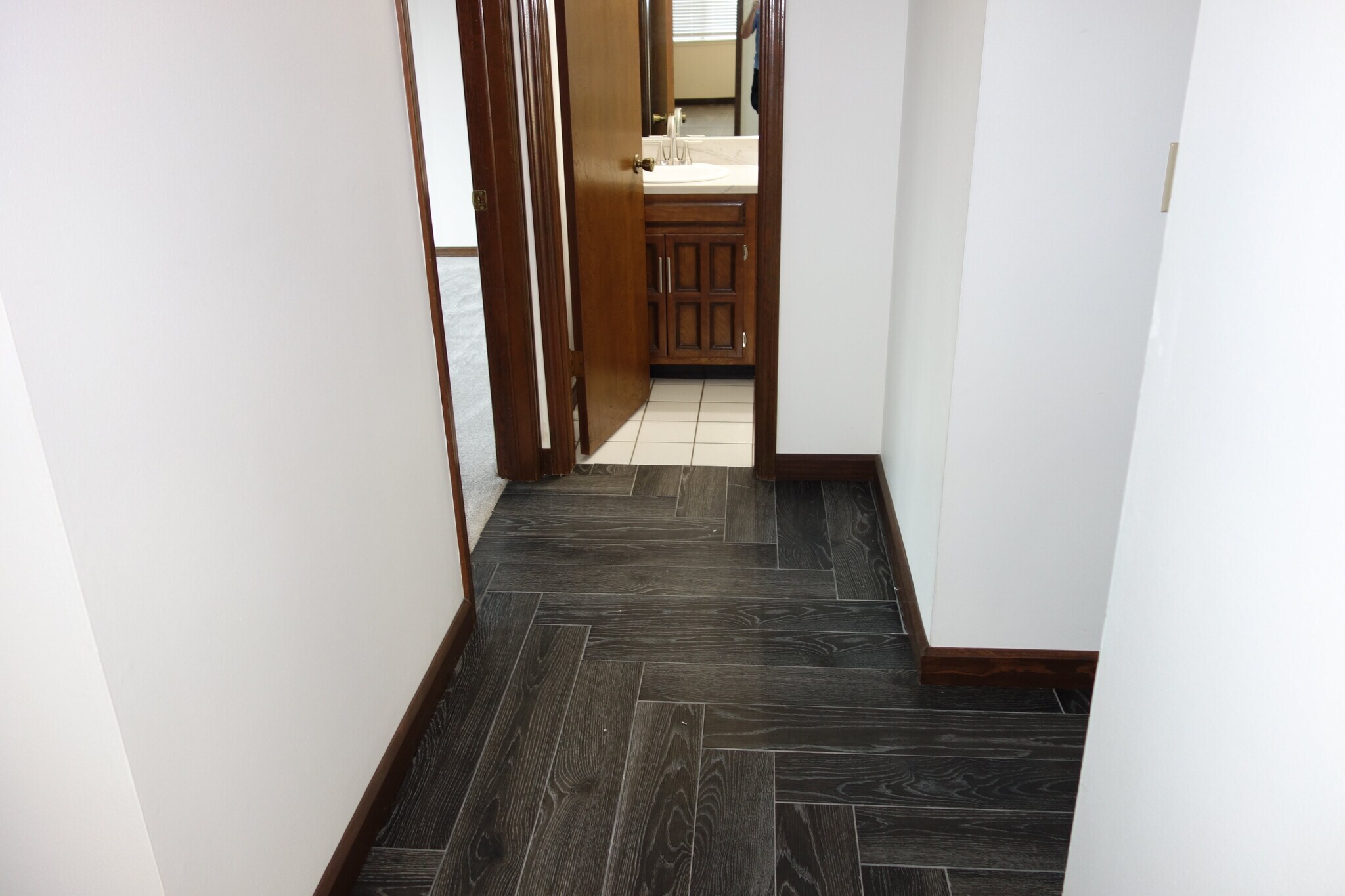 Tiled Hallway leading to 1st bedroom on left and bathroom ahead - 3324 E 73rd St