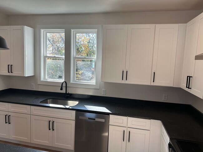 spacious kitchen with granite and stainless appliances - 200 Raymond St