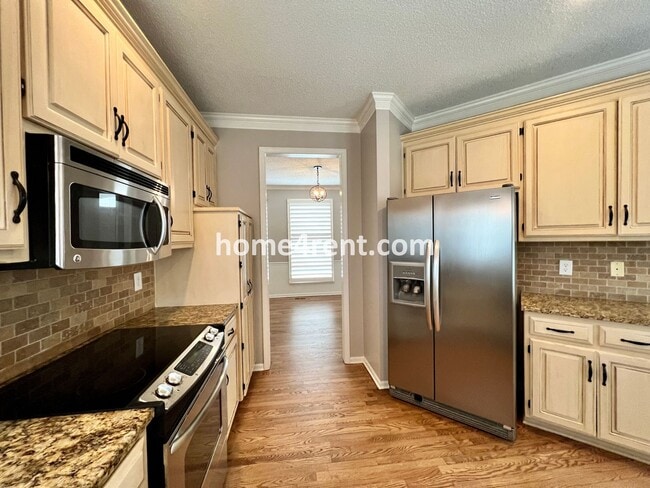 Building Photo - Updated Kitchen, Large Two Tiered Deck, Finished Basement in Blue Valley Schools!