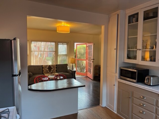 View from Kitchen out the front door into yard - 928 Marco Pl