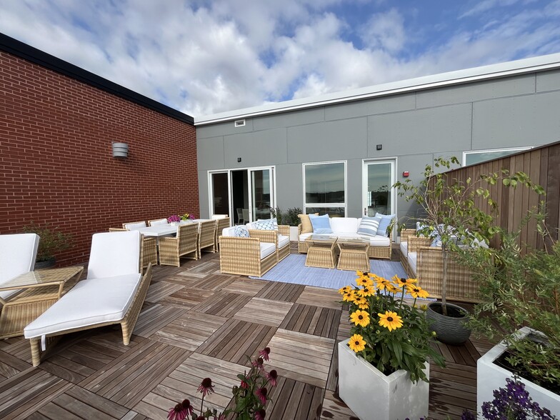 644 sq. ft. rooftop deck with all Serena and Lily furniture and throw pillows. - 387 Commercial St