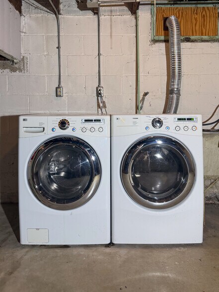 Front load washer and dryer in clean basement - 5411 W National Ave