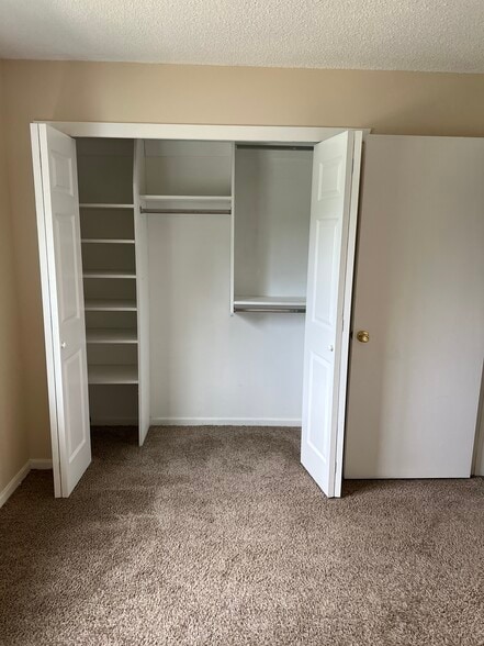 Bedroom 1 Closet with builtin shelves - 8308 Tamarron Dr