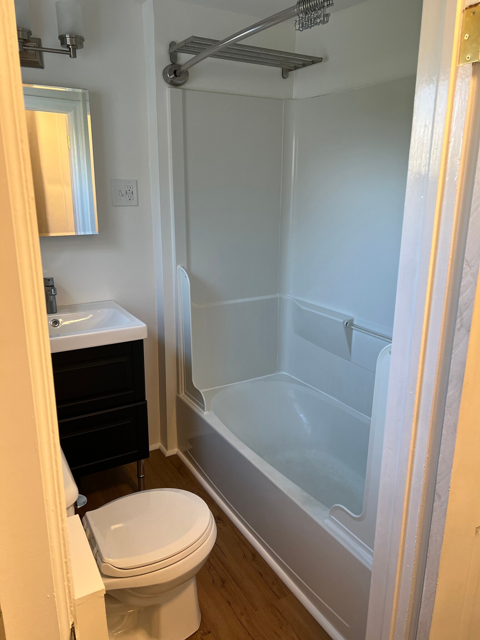 The bathroom has a good sized tub and shower with a drying rack above. - 126 Merion Ave