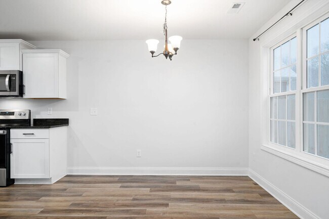 Building Photo - Pet Friendly Three Bedroom with Bonus!