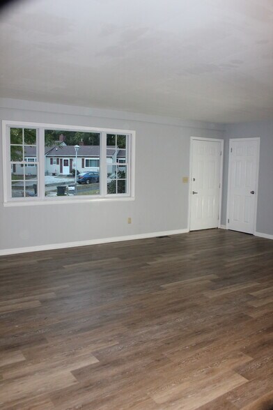 Open concept standing in dining area looking toward large, sunny living room - 573 Innkeeper Ln