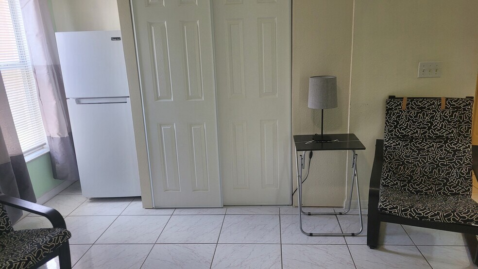 Closet, refrigerator and relaxing chairs - 106 Woodbury Pines Cir