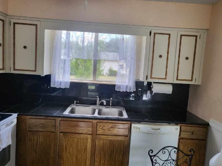 Kitchen with granite countertops and backsplash - 10871 SW 90th Ct