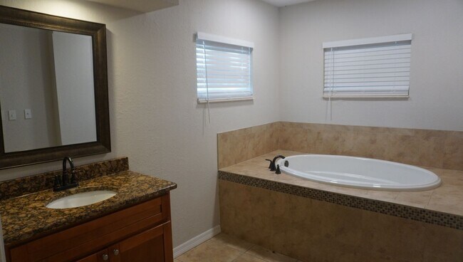 Building Photo - Four Bed - Three Bath - Large Storage Area...
